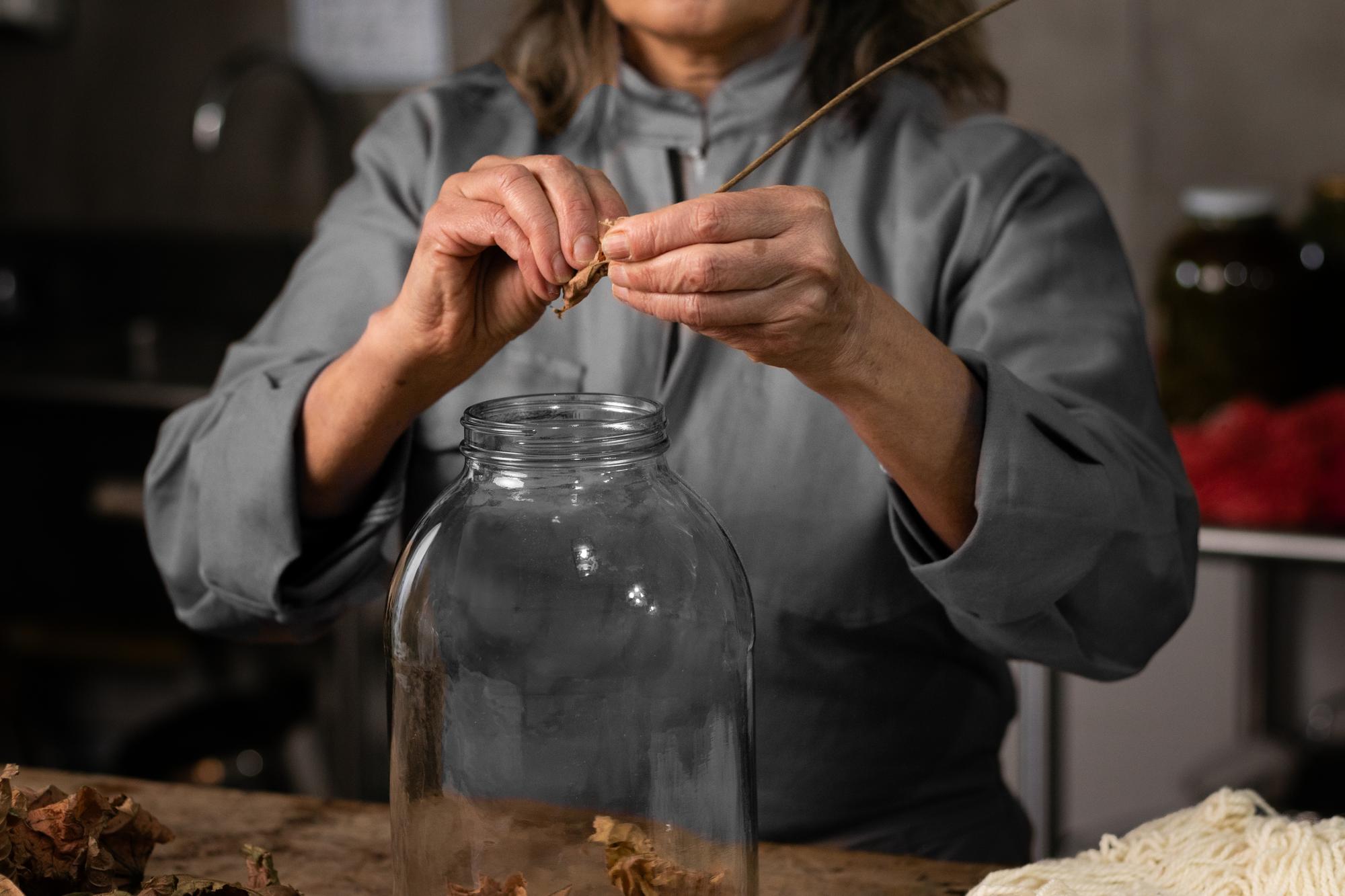 chef in workshop arranging jars