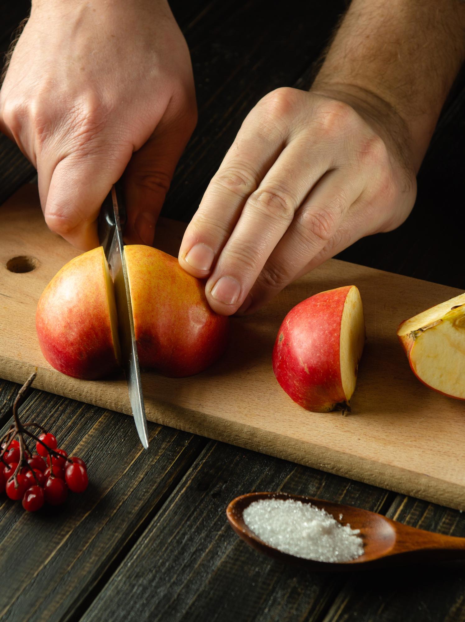 chef slicing seasonal fruit for preserves