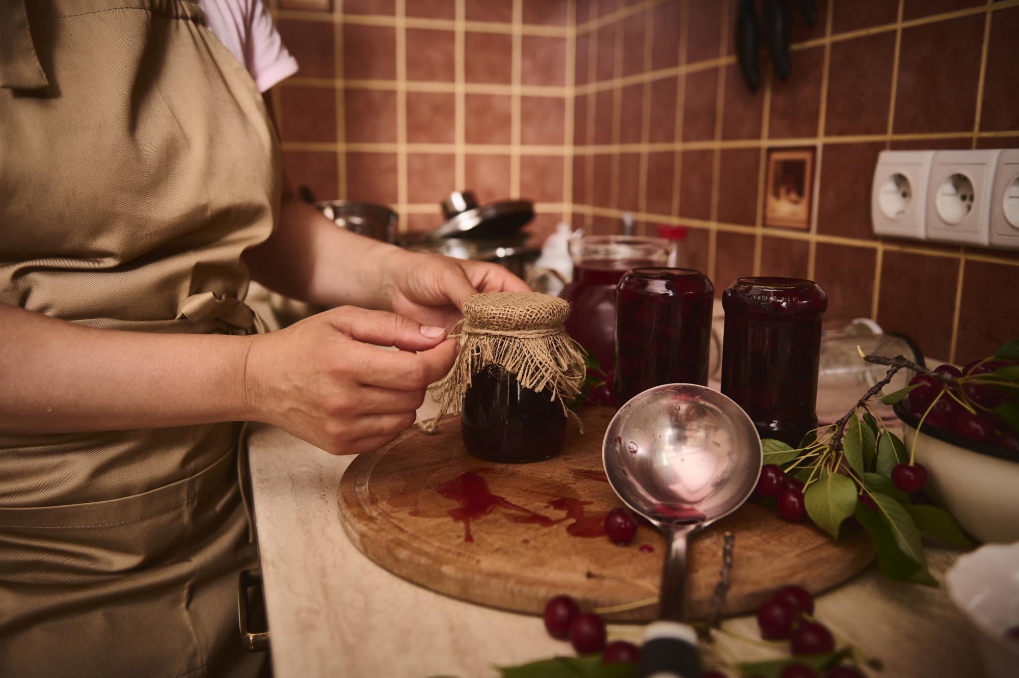chef arranging artisanal jars on wooden table